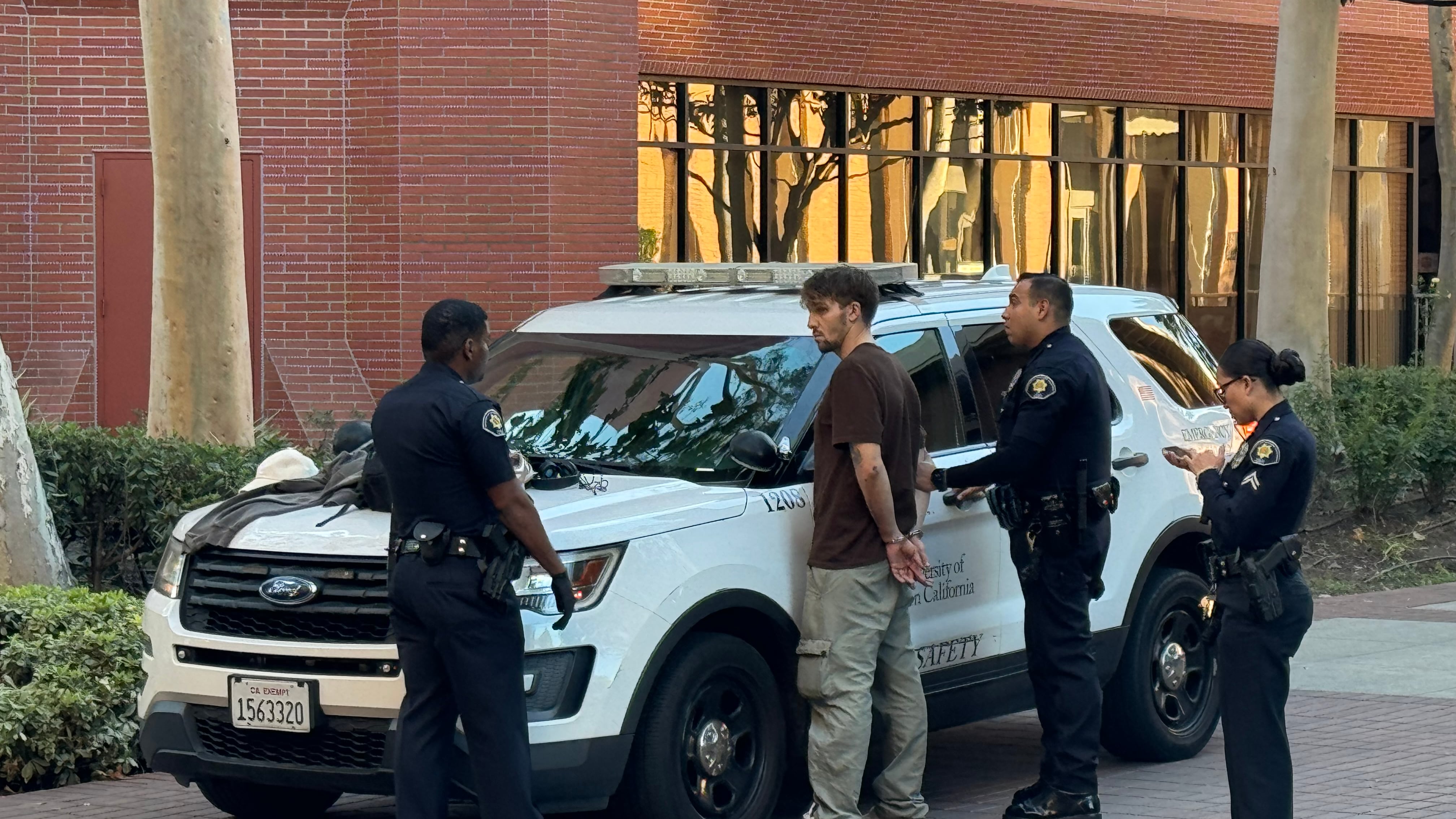 Photo of an alleged shoplifter being detained by USC Department of Public Safety officers. (Photo by Malcolm Caminero)