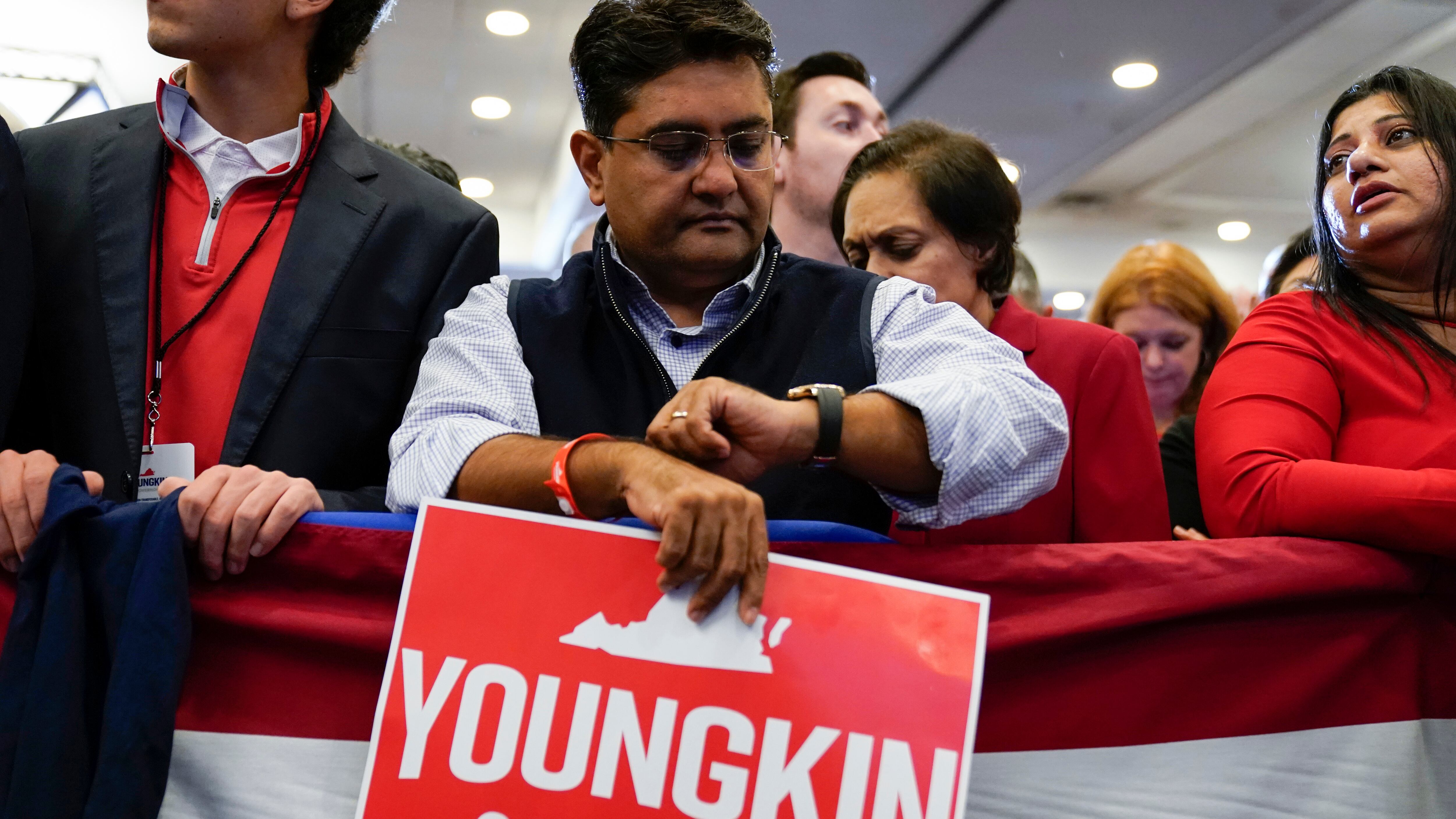 A man holds a sign saying "Youngkin Governor" at a rally for Virginia gubernatorial candidate Glenn Youngkin.