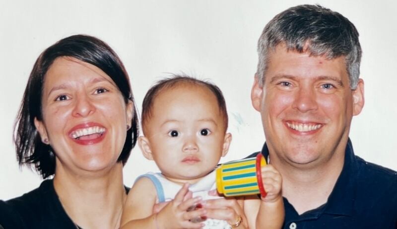 Photo of two people and a baby