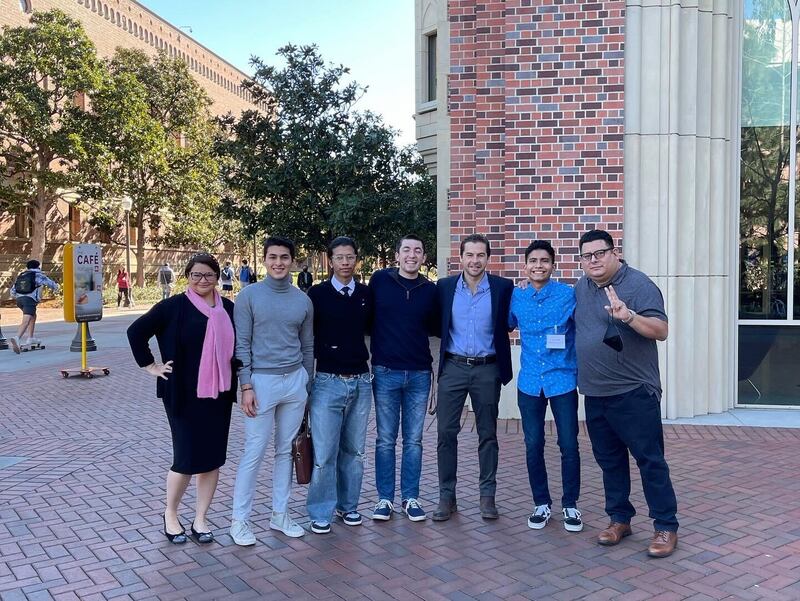 "A photo of Julio Vaqueiro posing with USC students and faculty."