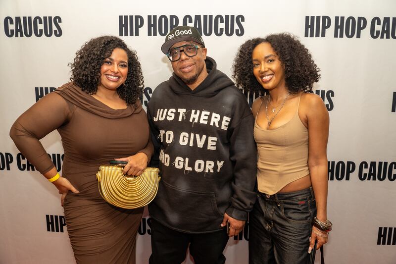 Woman in brown dress and brown cami with jeans. Man in black hoodie that says "Just here to give God glory."