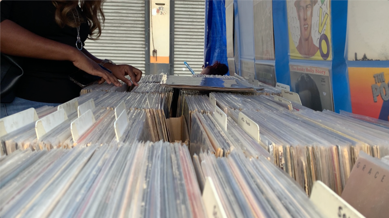 A photo of someone rifling through vinyl records.