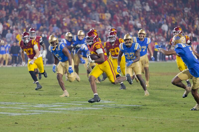 Football player running from other players