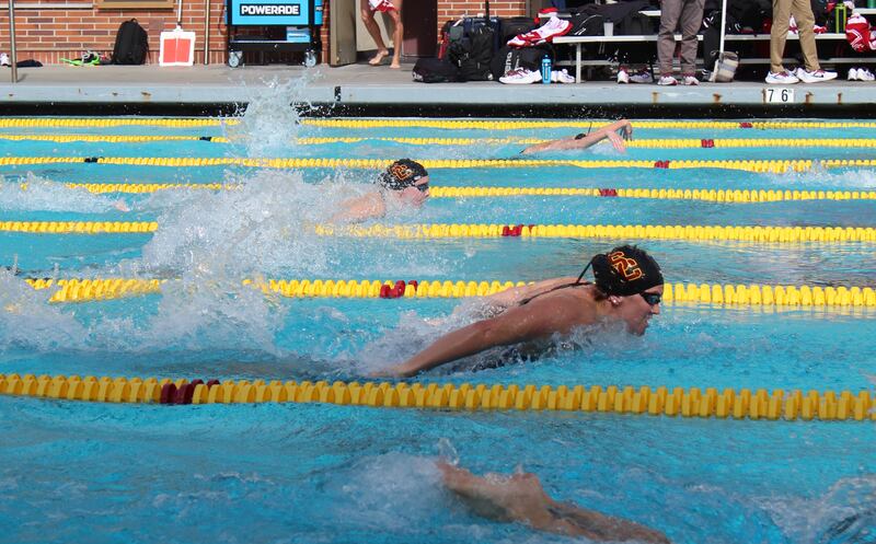A picture of two USC swimmers at Uytengsu Aquatics center doing the breaststroke.