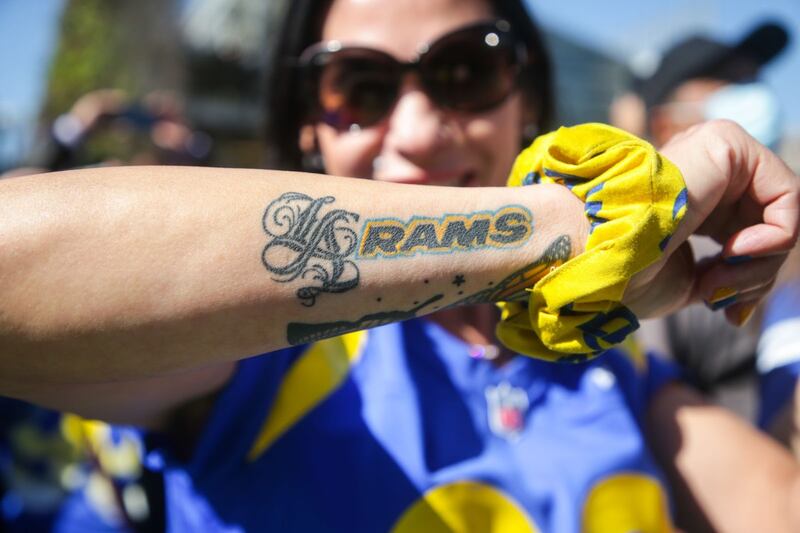 A fan shows off her Rams tattoo as she stands behind the barricades at the victory parade. (Photo by Yannick Peterhans)