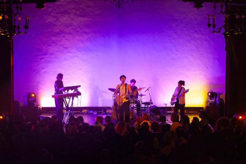Crowd watches a band on stage