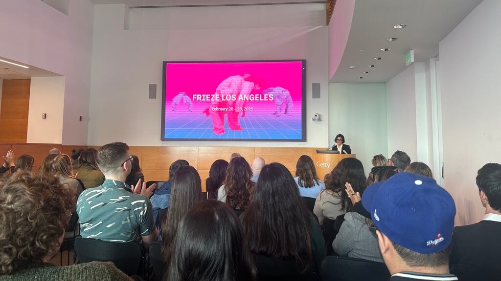 a powerpoint presentation given to a group of people in a lecture hall