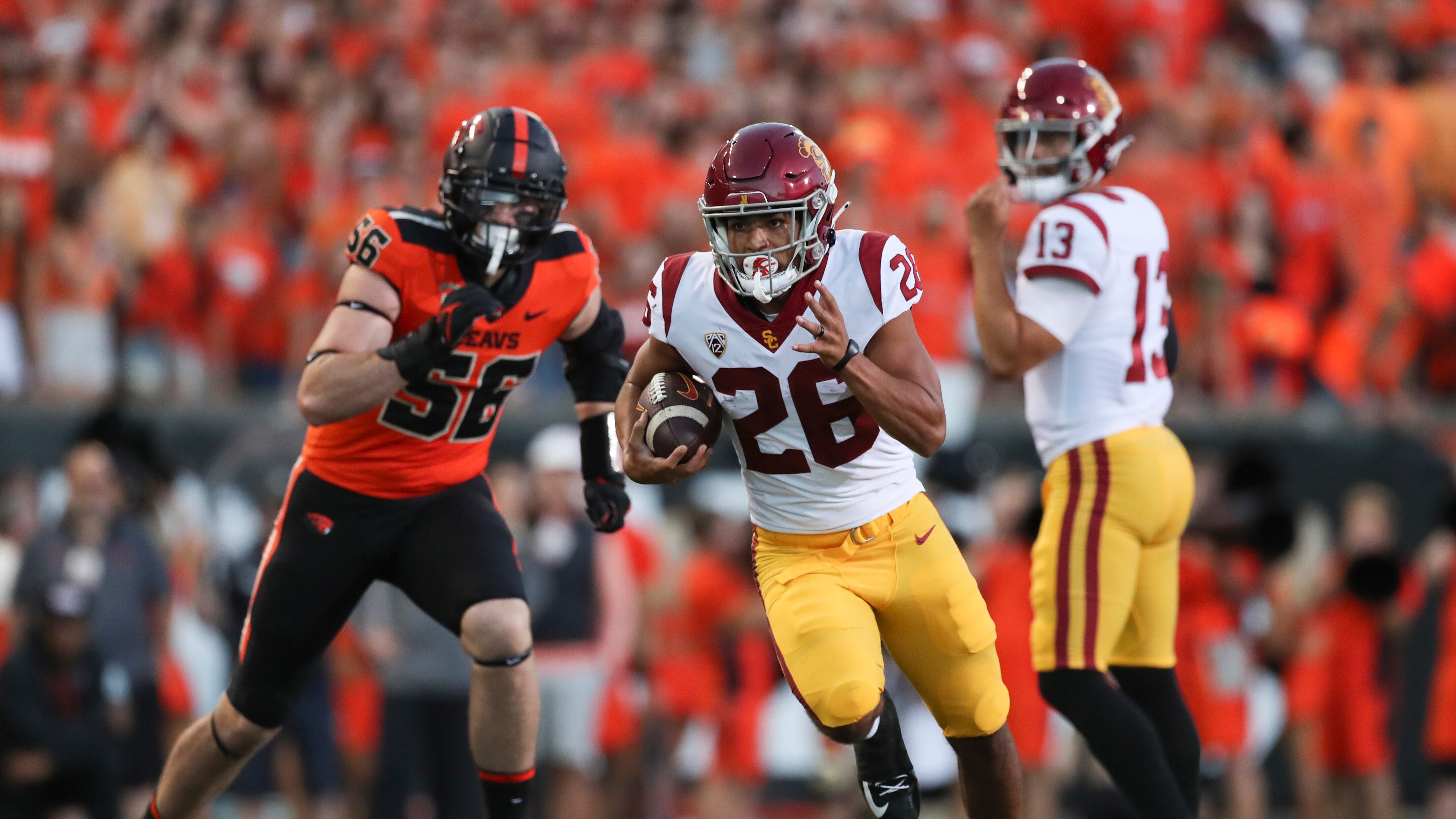 Travis Dye runs the football in Corvallis against Oregon State. (Photo courtesy of the AP)