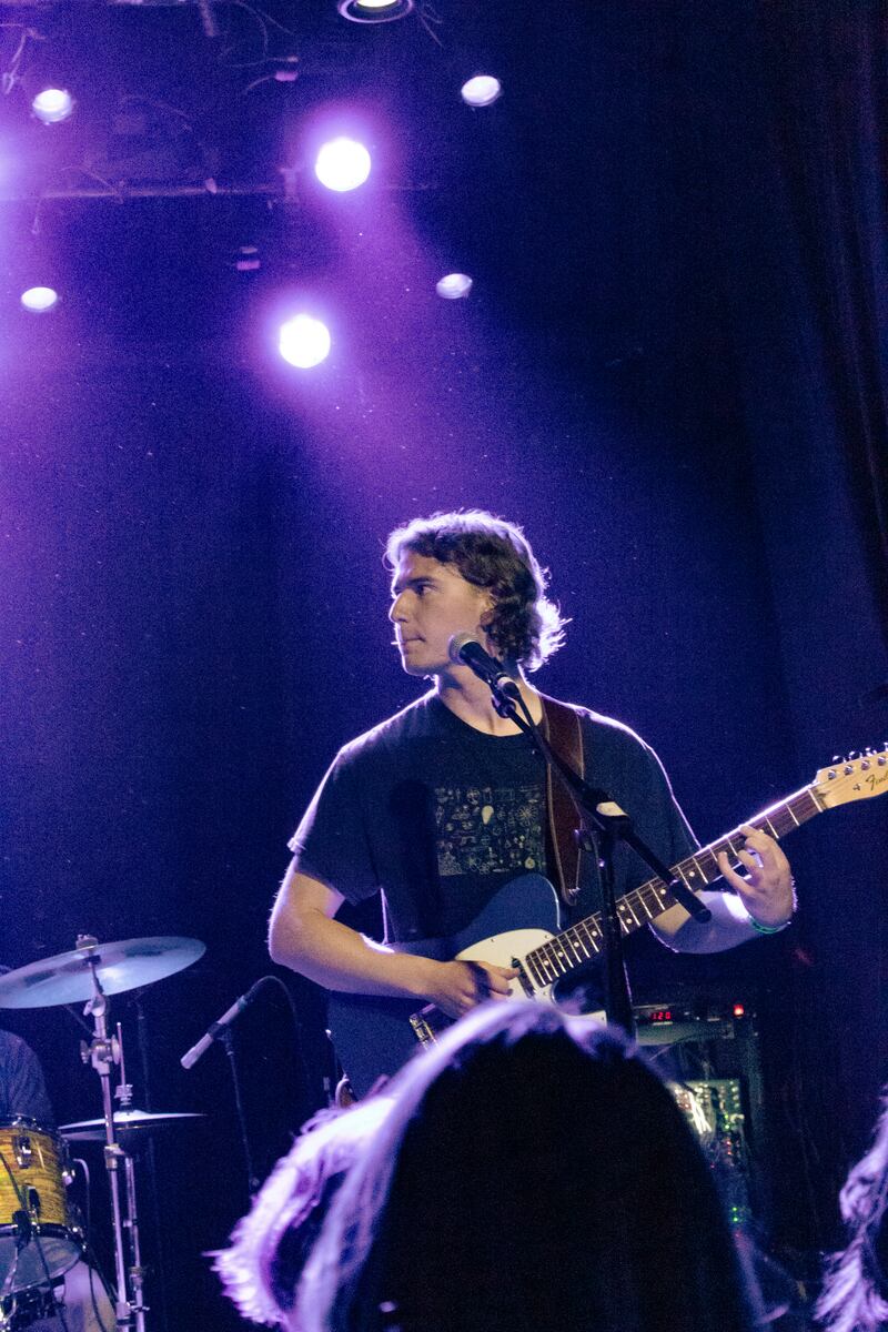 Guitarist Gage Clisby looks off to the side of the stage during "Annabeth," a song which he wrote. (Photo by Marissa Ding)