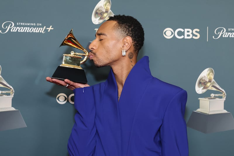 R&B singer-songwriter Durand Bernarr kisses his Grammy Award