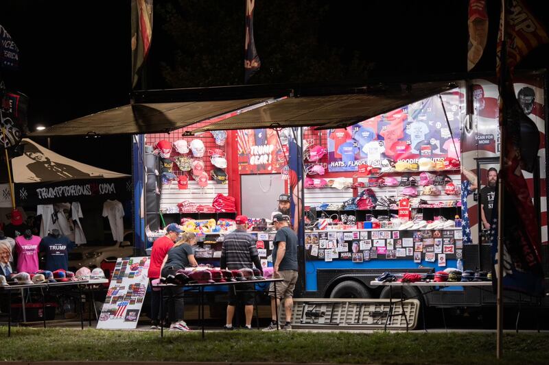 A merch booth selling various items promoting Donald Trump.