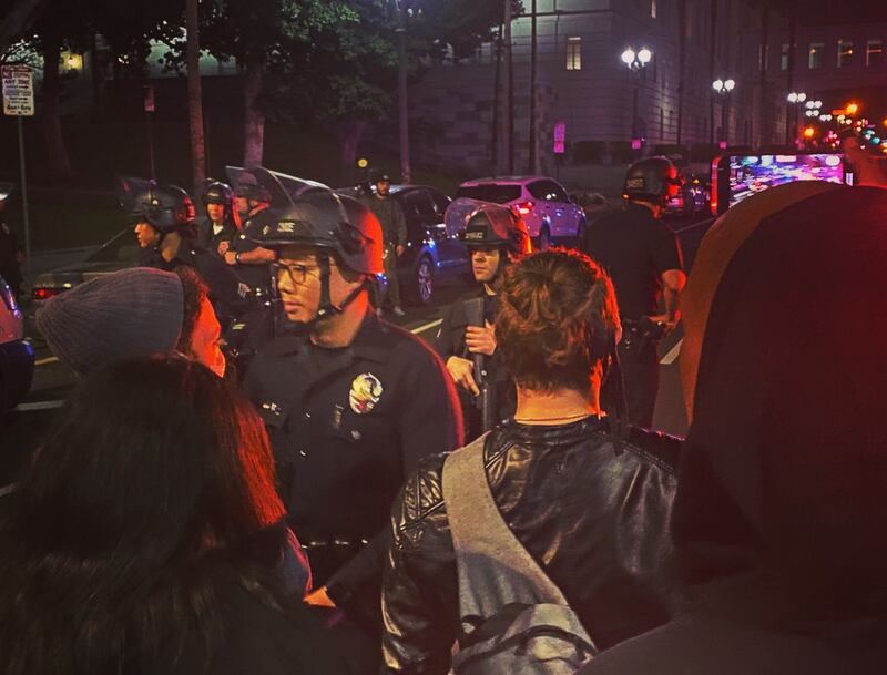 [Photo of protestors in stand off with LAPD HQ.]