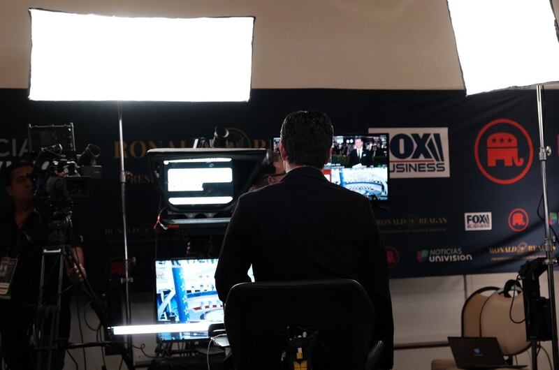 A reporter goes live on camera and reads off his teleprompter.