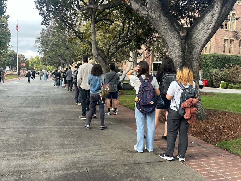 Photo of people waiting in line.