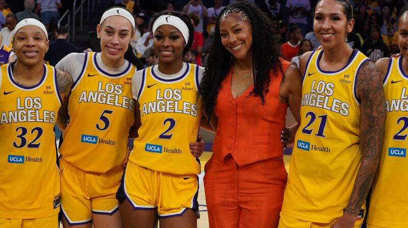 Photo of Los Angeles Sparks great Candace Parker poses with current Sparks players at Crypto.com Arena.  Photo by Dominique Williams.)