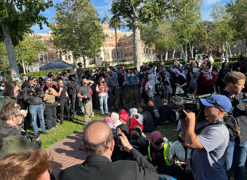 Group of people sitting in circle on grass