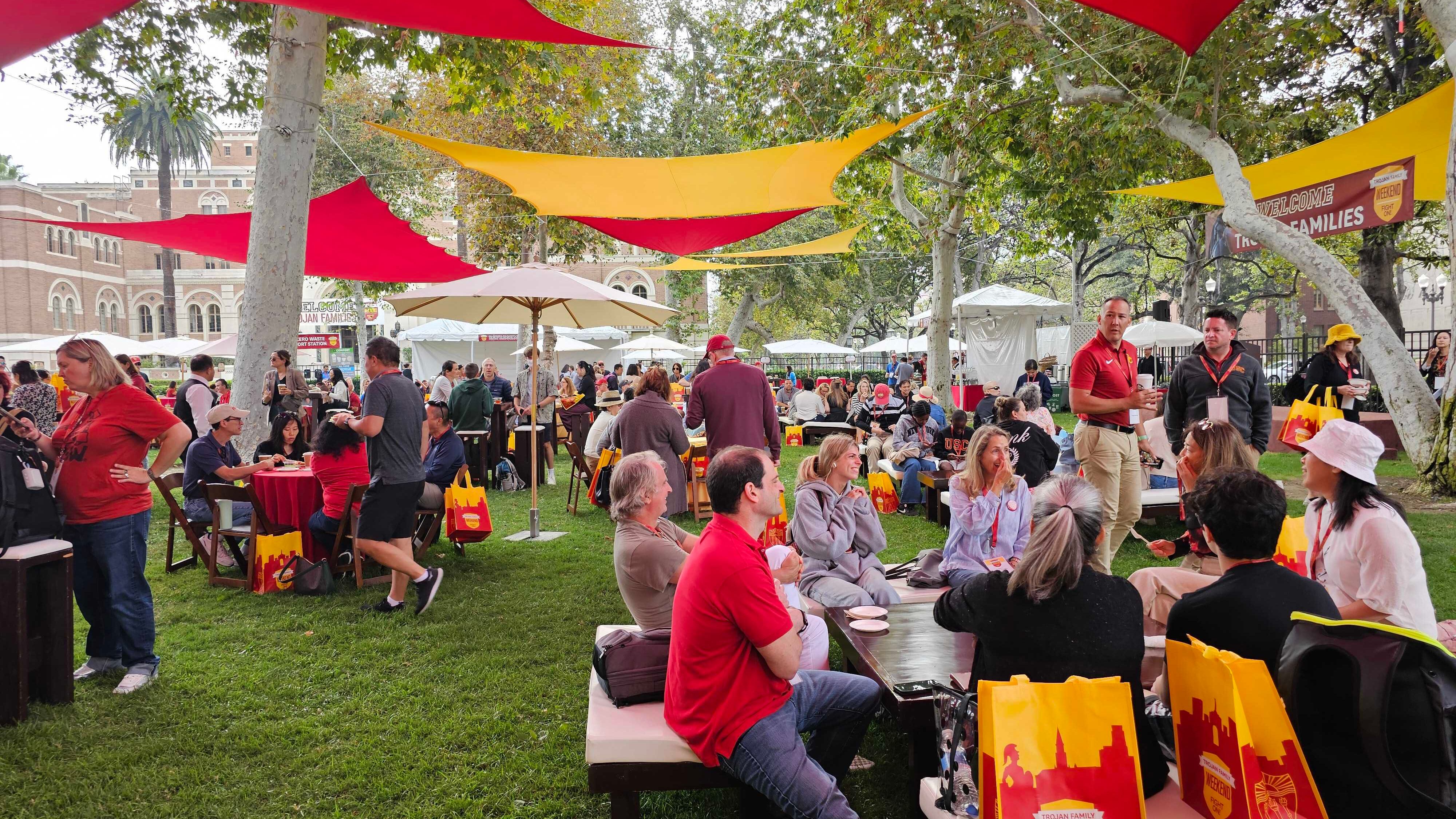 Photo of families at the Trojan Family Weekend welcome event, sitting at tables.