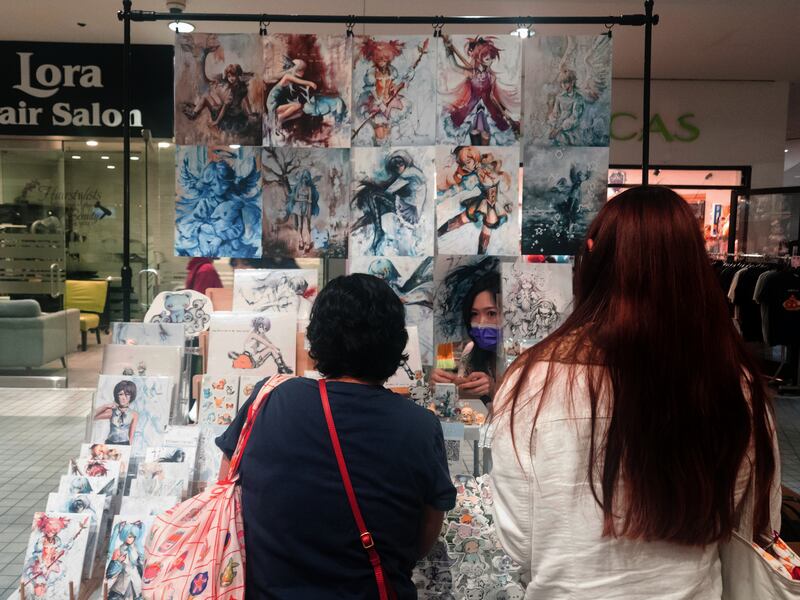 Artist showing off stuff for sale