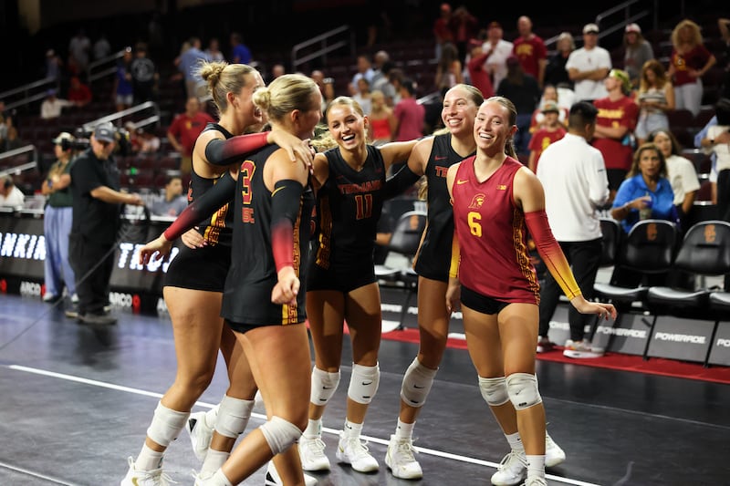 USC women's volleyball team celebrating on court after win over Creighton.