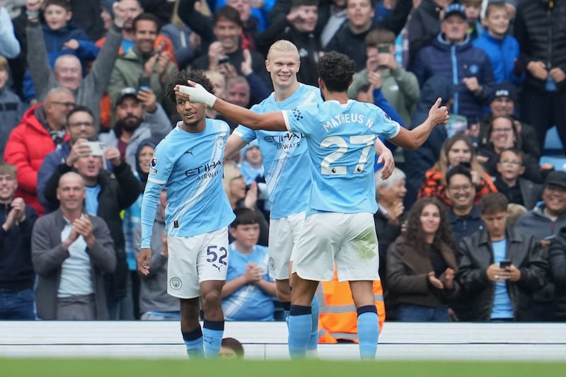 Manchester City's Erling Haaland, center, reacts after scoring during the Premier League soccer match between Burnley and Manchester City in Manchester, England, Saturday, Sept. 27, 2025. (AP Photo/Jon Super)