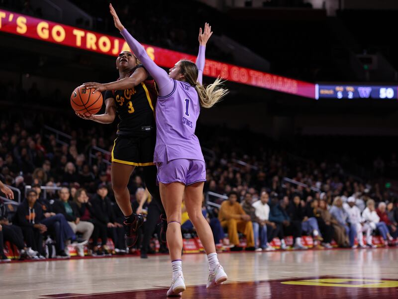 Londynn Jones (3) drives on a Washington defender with basketball in hand at Galen Center.