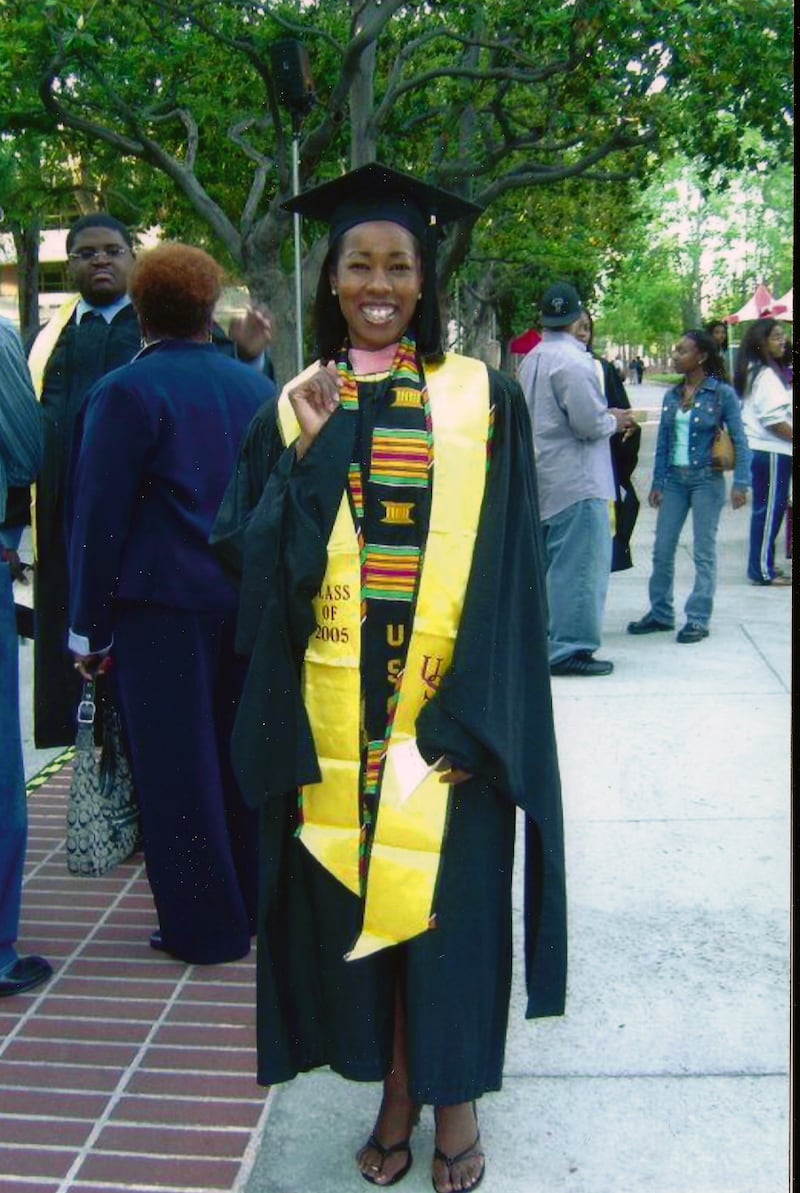 Nicole Vick poses in her graduation robes.