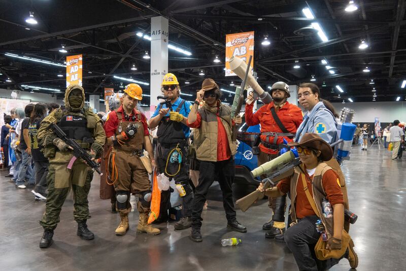 Cosplayers take a photo together
