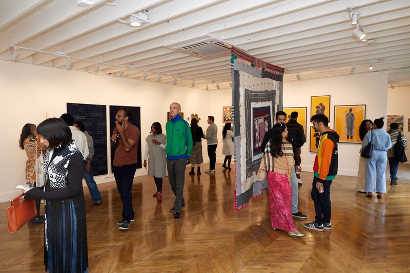 Photo of a group of people walking around a gallery