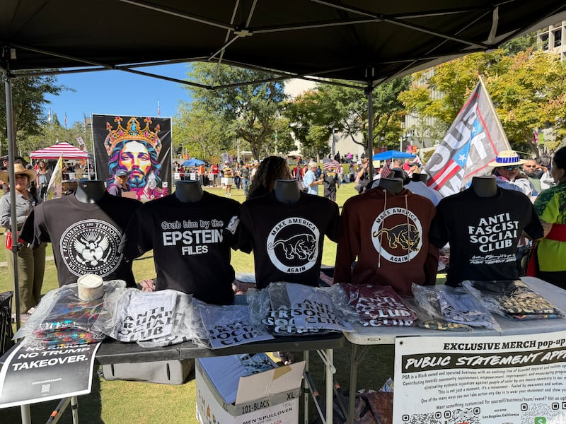 Merchandise, inclduing shirts reading "grab him by the Epstein files," was sold during Downtown Los Angeles march.