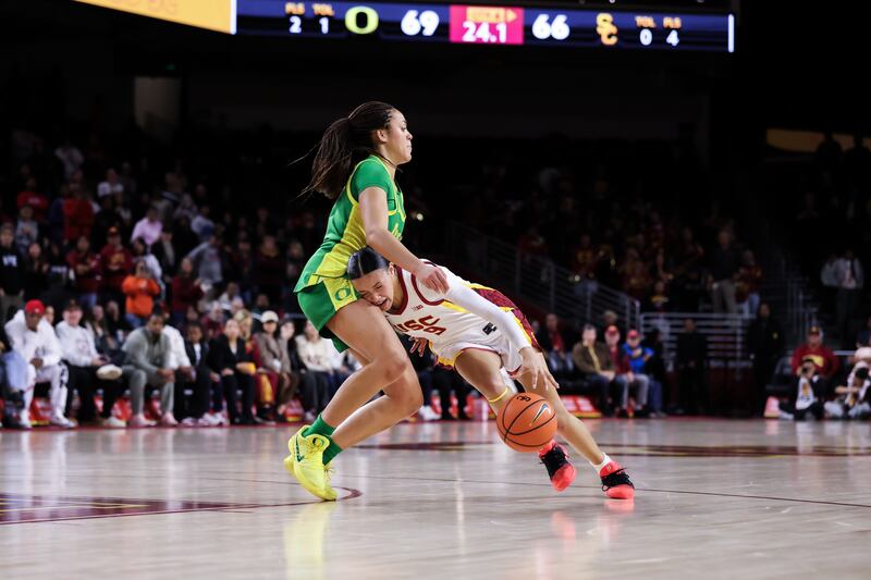 Jazzy Davidson (9) drives the ball to the basket on an Oregon defender at Galen Center.