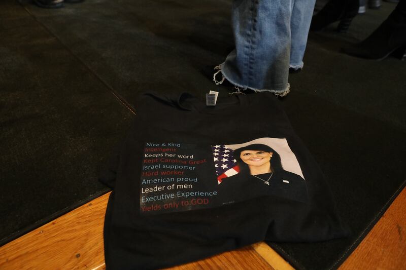 a black t short with Nikki Haley's face on it on a chair