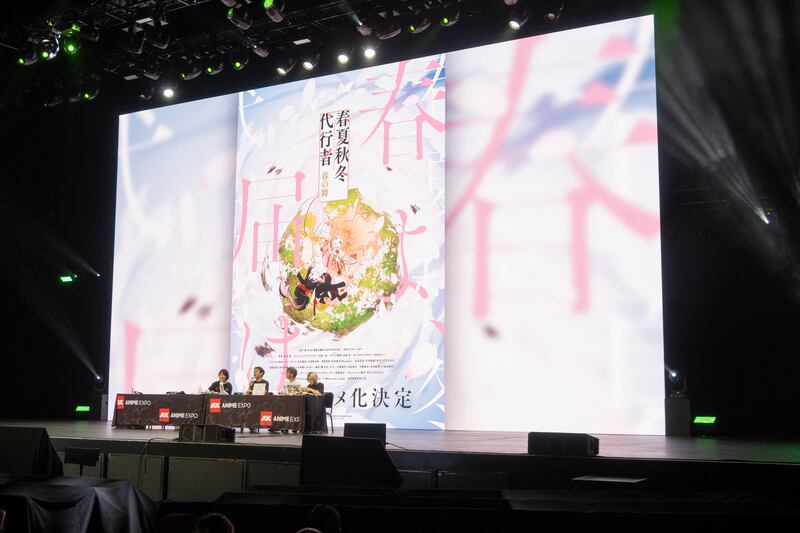 Panelist on stage talking about shows