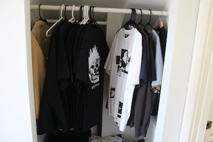 Photo of T-shirts on a rack.