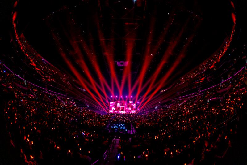 Fans match the color of their light sticks with the stage