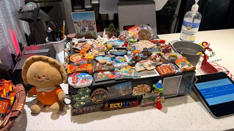 Photo of a cash register decorated with magnets.