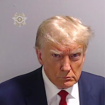 Photo of Blonde man arrested. President Trump lined up for mugshot.