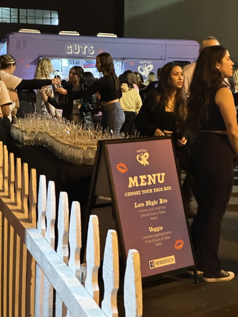 Photo of a menu that reads "Late Night Bite" and "Veggie" in front of a purple food truck.