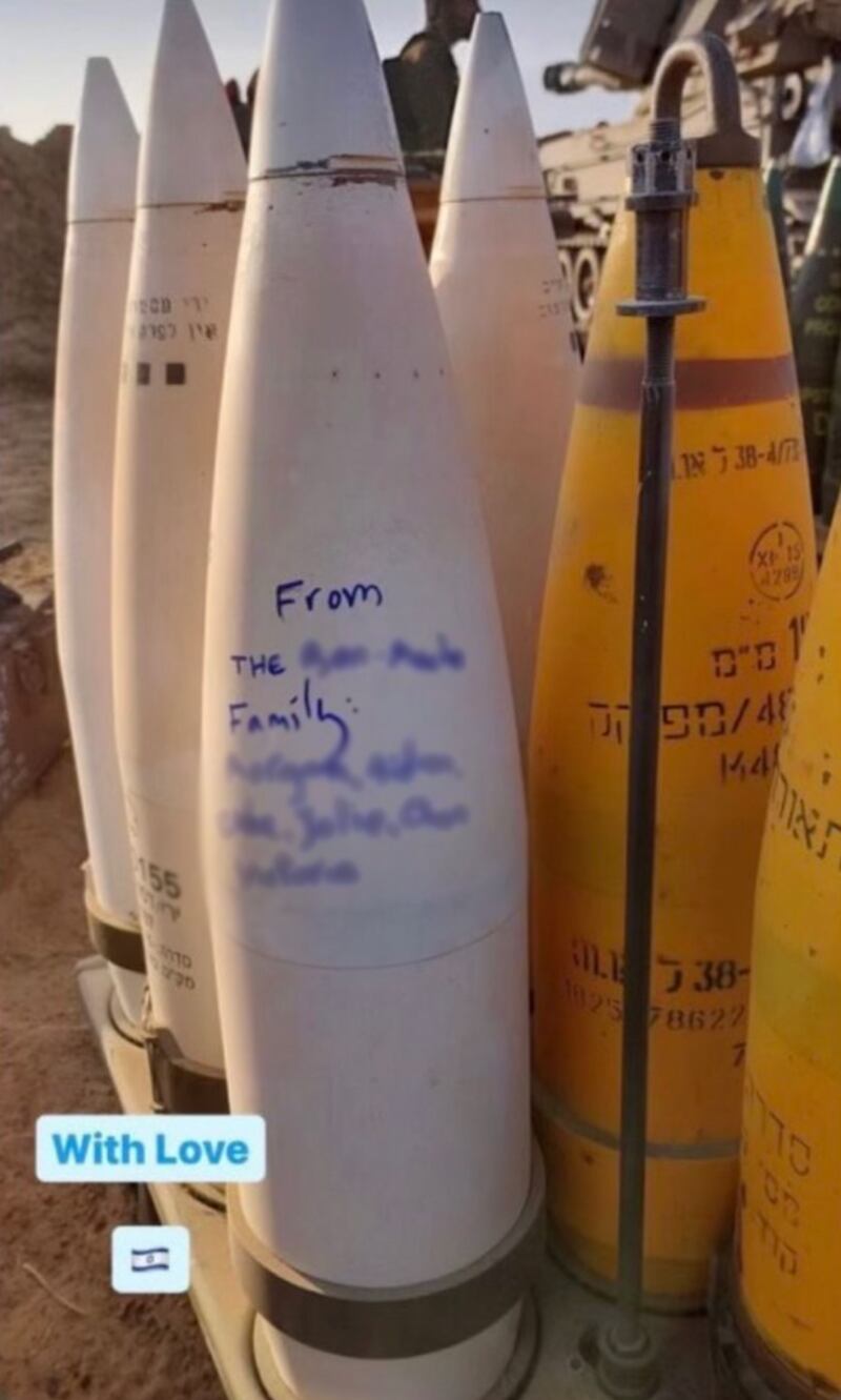 Image of bombs with one showing the writing "From The [blurred] Family: [blurred]" and the caption "With Love" and an Israeli flag emoji.