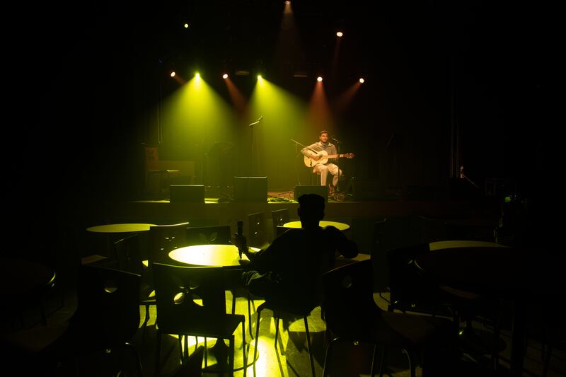 Tables centered near the front were mostly empty, but around 30 students were watching the performances from different places around the underground venue in couches on the periphery or at tables in the middle of the large room.