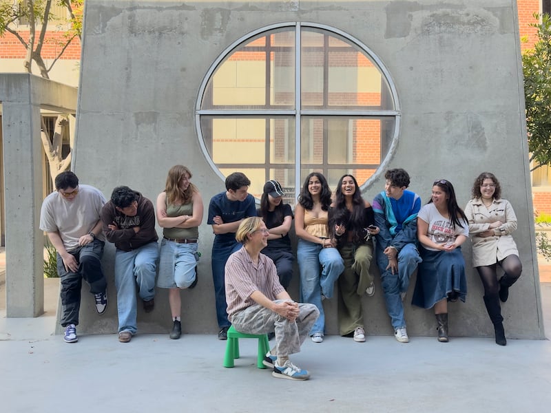 Photo of Kelley sitting in front of a row of smiling students from his Art 450 class.