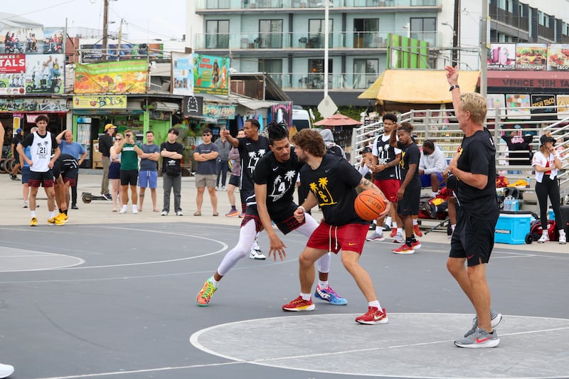 Chad Baker-Mazara (4) defends a USC practice player at Venice Beach as spectators look on.