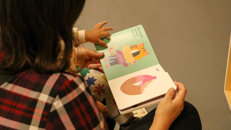 Photo of a child's hand on a children's book.
