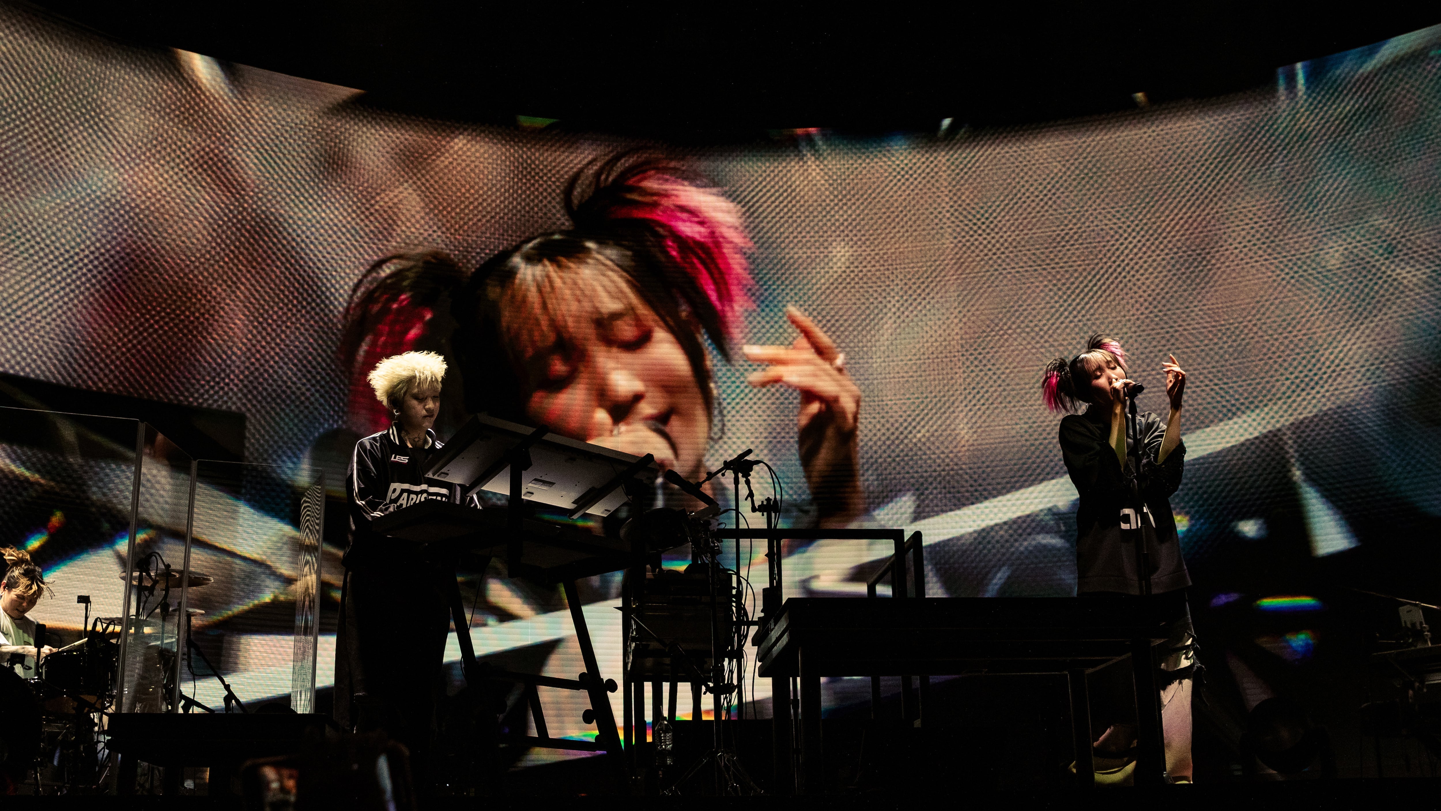 Photo of a keyboardist and a singer on a stage