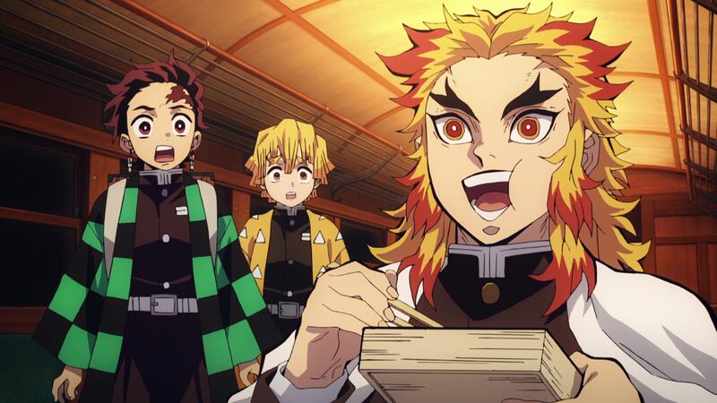 [Tanjiro and Zenitsu look on in surprise as Kyojuro is eating happily.]
