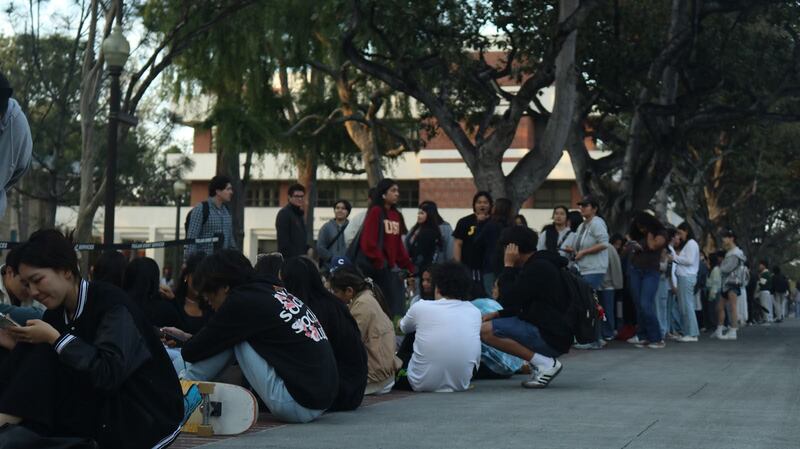 A long line of students wait outside of Bovard auditorium