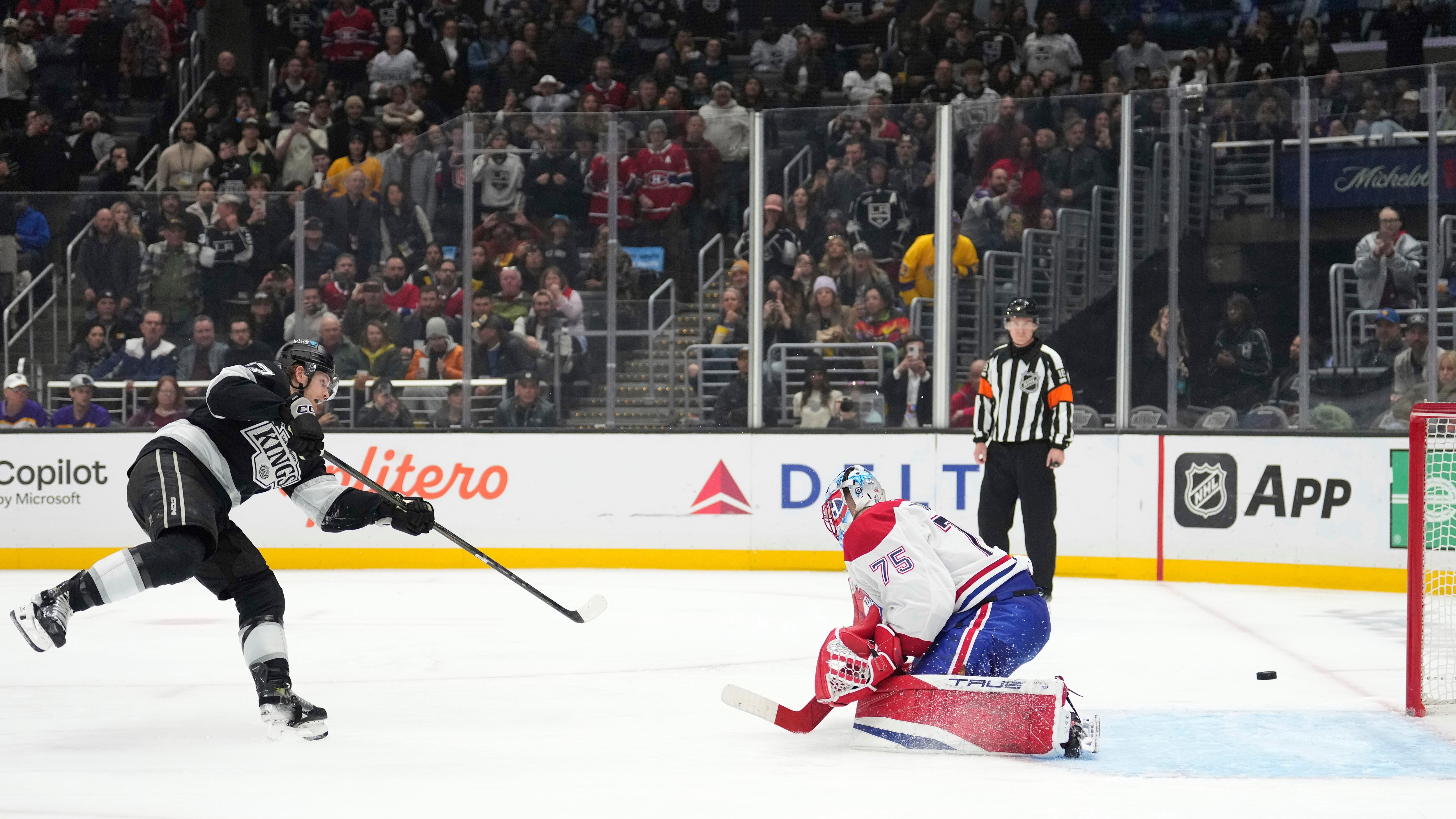 Los Angeles Kings left wing Warren Foegele, left, scores on Montreal Canadiens goaltender Jakub Dobes during a penalty shot in the second period of an NHL hockey game, Wednesday, Feb. 5, 2025, in Los Angeles. (AP Photo/Mark J. Terrill)