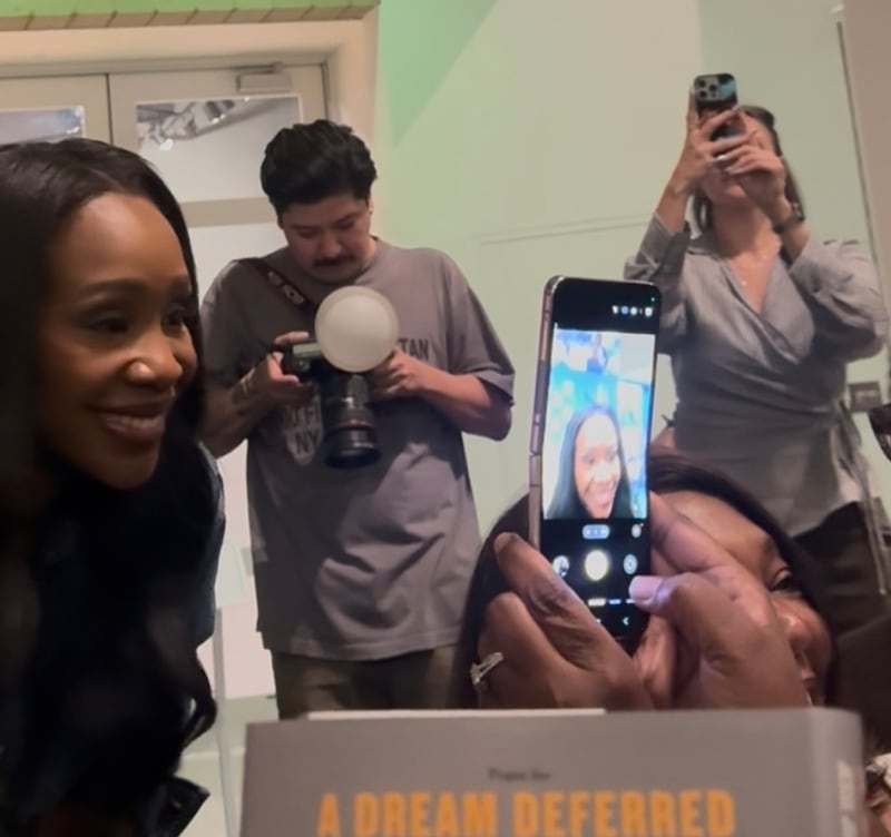 Abby Phillip takes photos with fans after her Q&A panel.