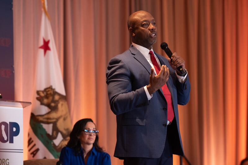 Tim Scott with a microphone giving his speech.