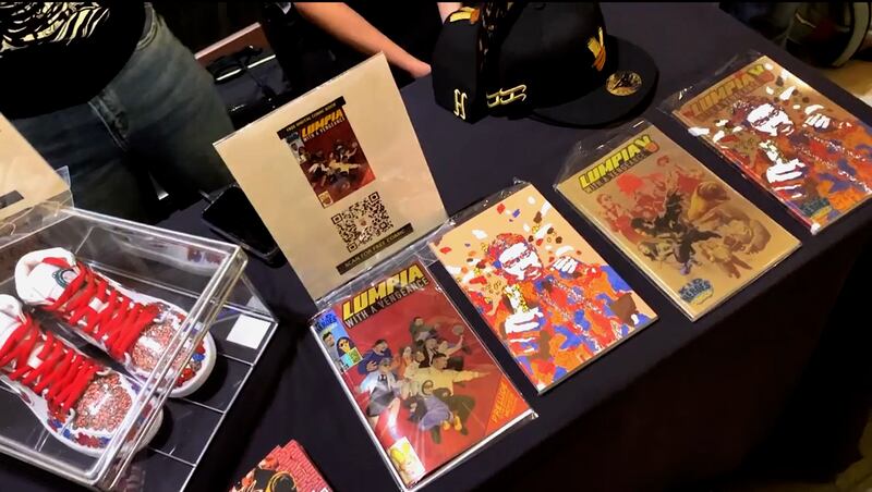 A table with colorful "Lumpia" comic books and sneakers.
