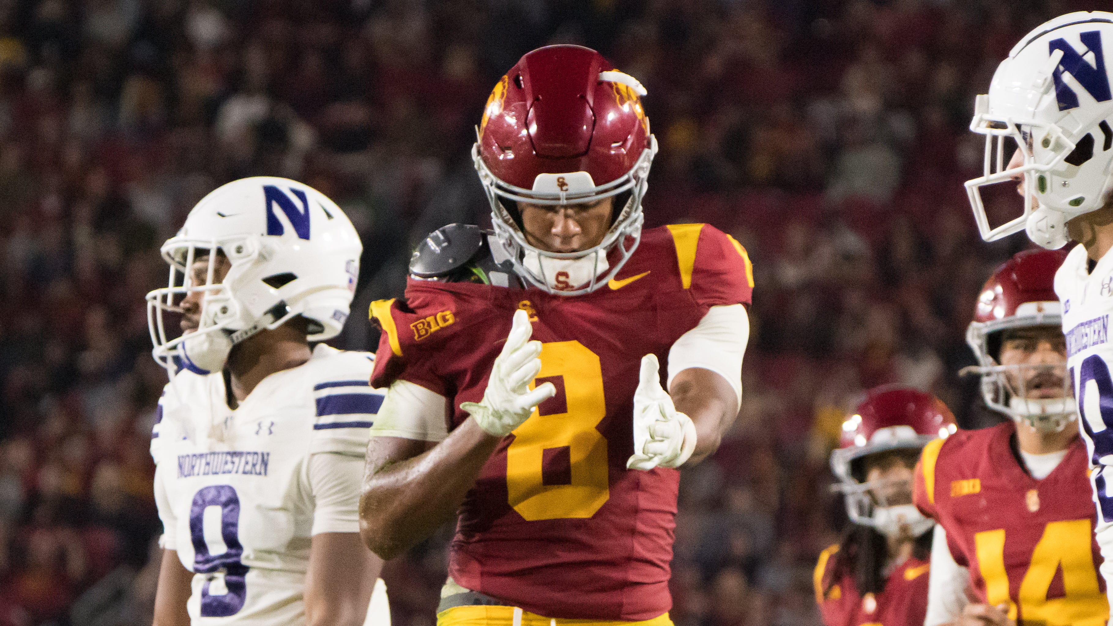 USC wide receiver Ja'Kobi Lane celebrates first down after having his jersey pulled down off of his shoulder pad.